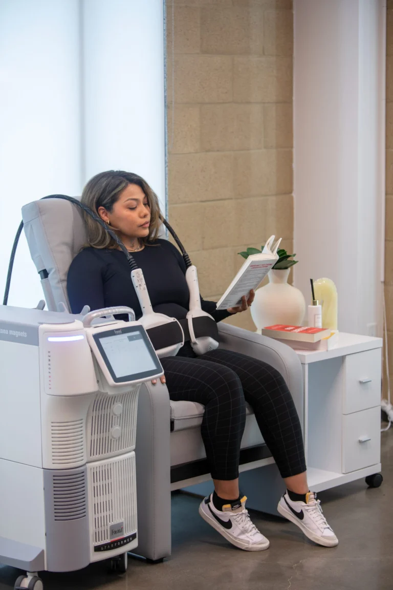 Woman seated in the Fotona StarFormer chair during CoreRestore treatment